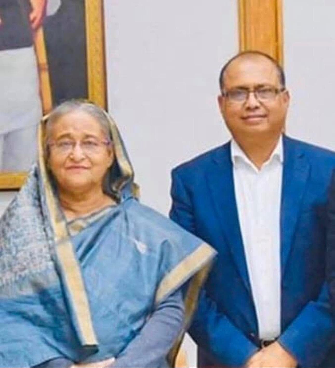 A formal portrait frame of Sheikh Hasina alongside a community representative
